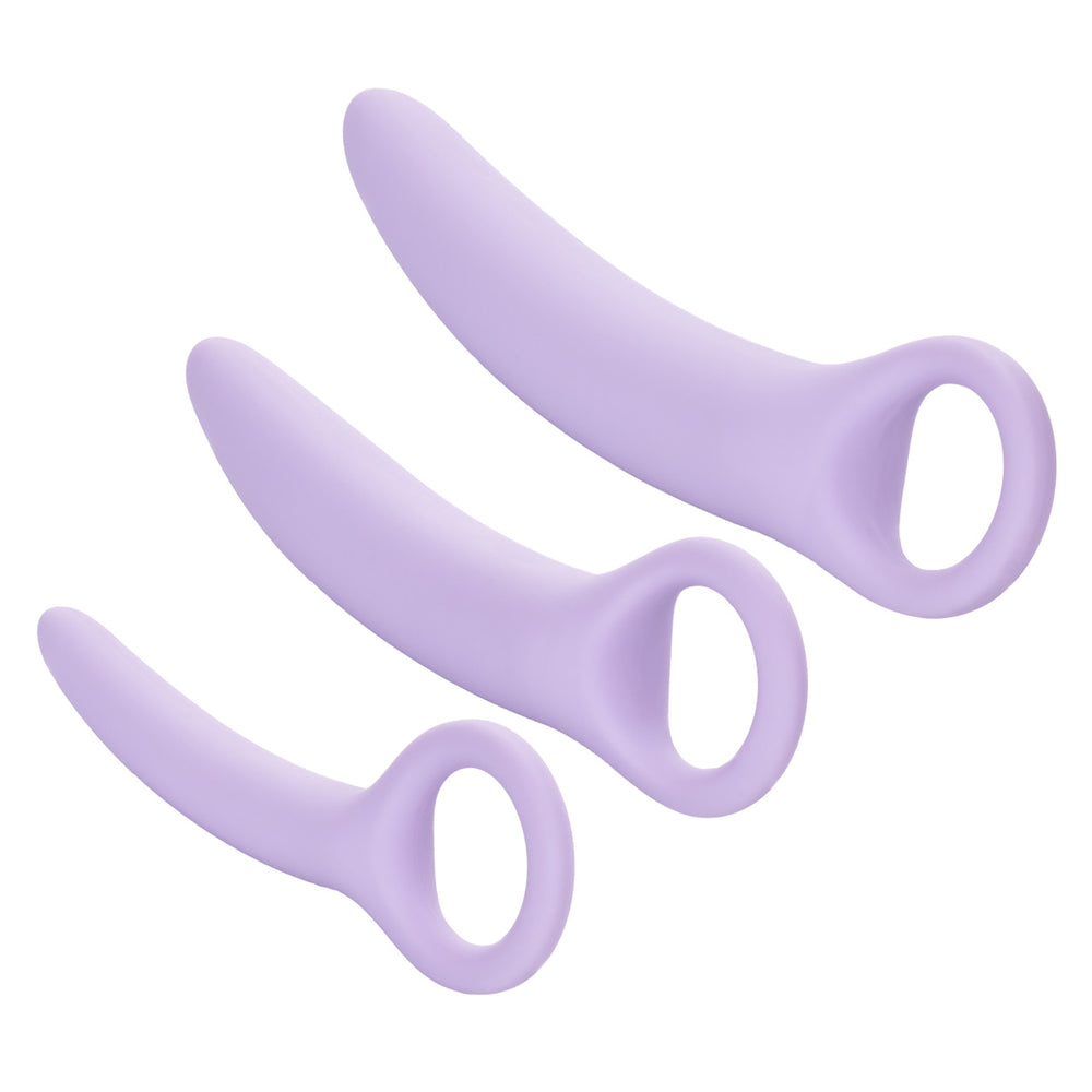Three lavender silicone vaginal dilators of varying sizes.