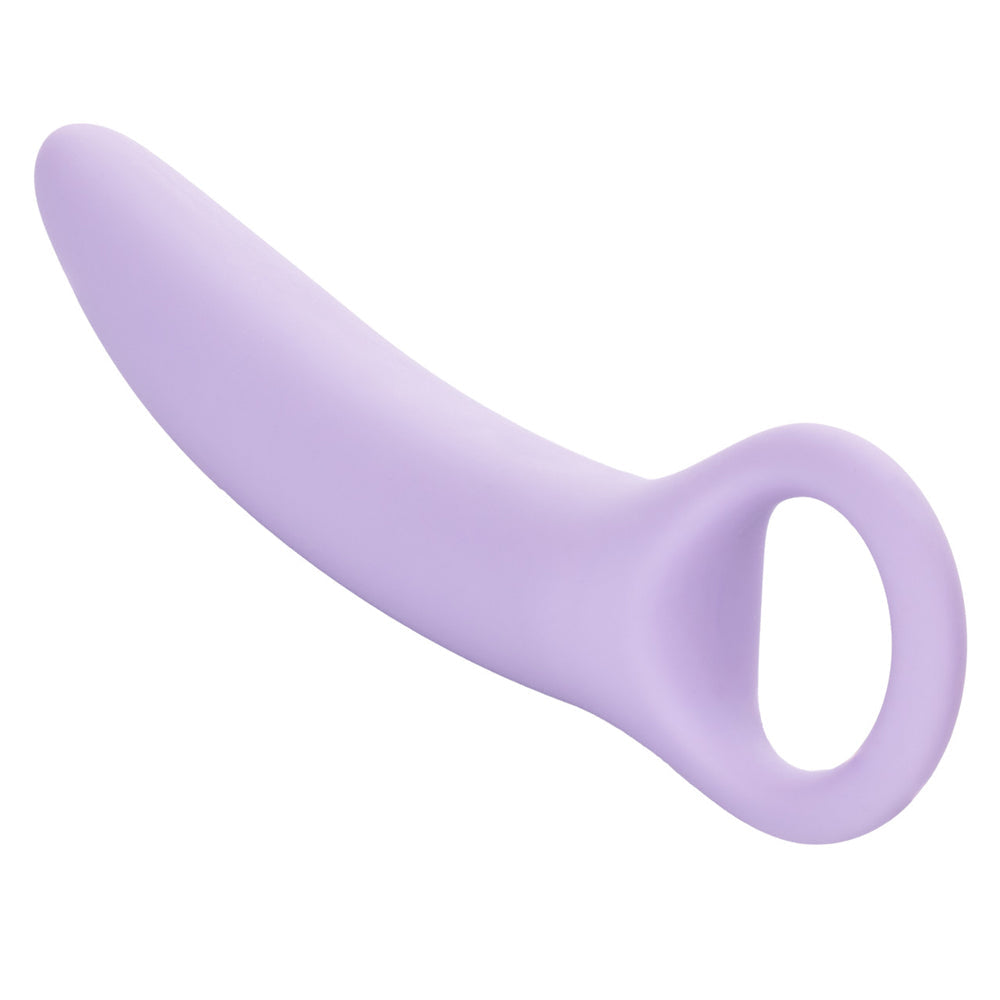 A curved, light purple silicone vaginal dilator with a finger loop.