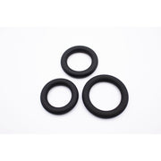 Three black silicone rings of varying sizes on a white background.