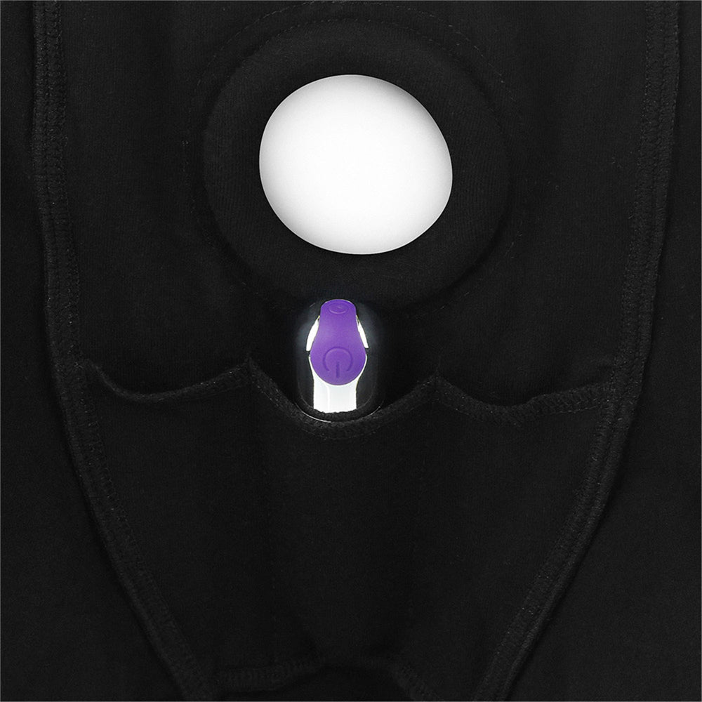 Black boxer shorts with a purple vibrator in a pocket and a white circle.