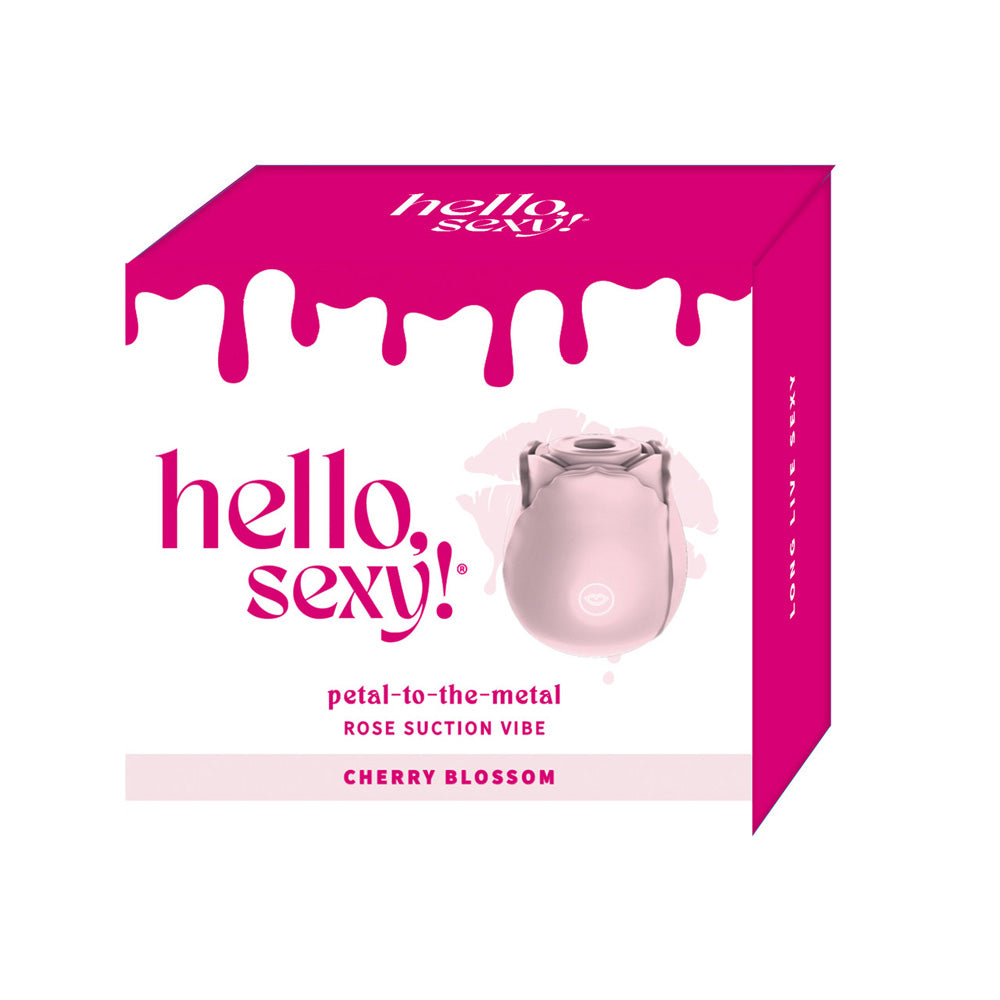 A pink rose-shaped suction vibrator on a box with "hello, sexy!" branding.