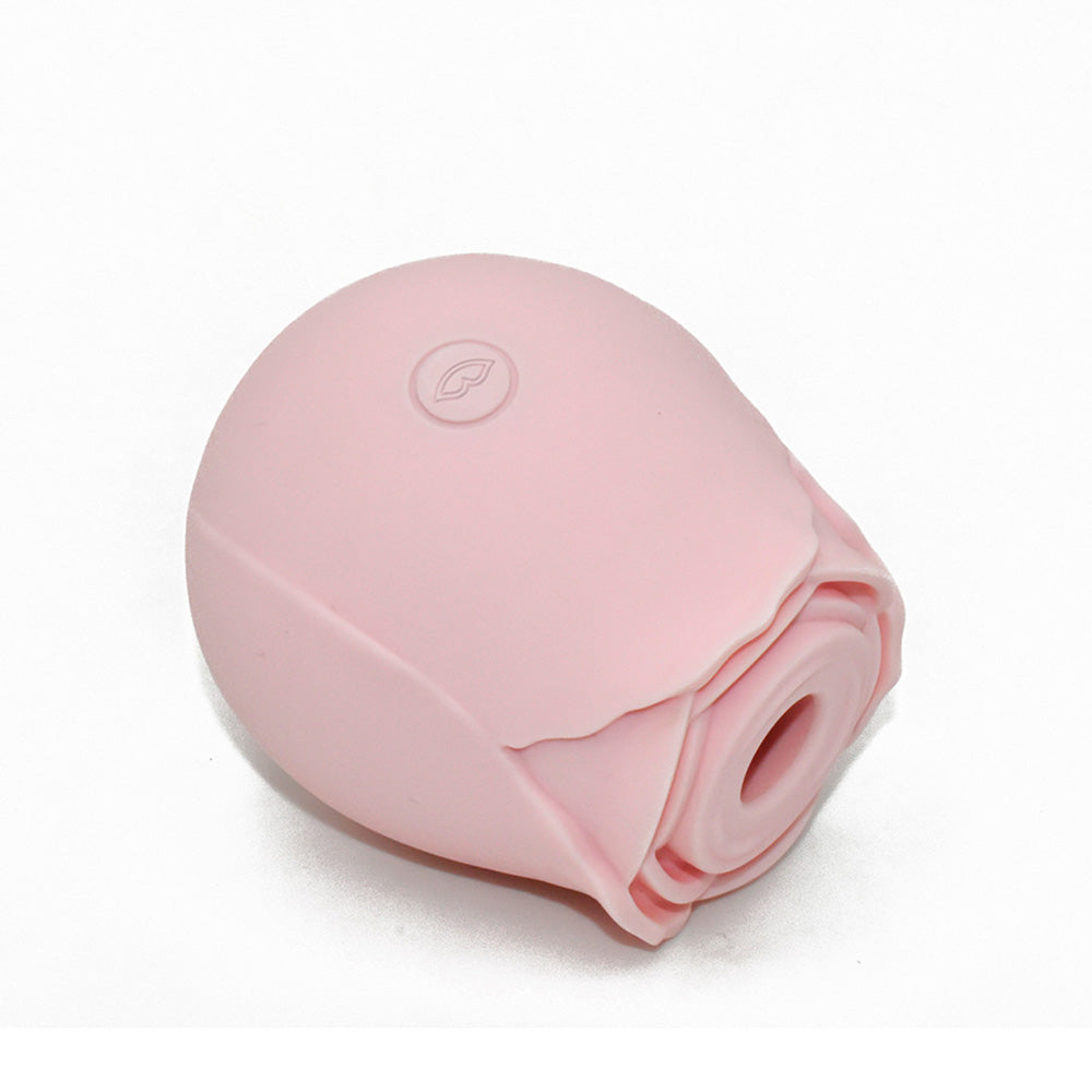 A pink rose-shaped vibrator with a textured petal design and a circular button.
