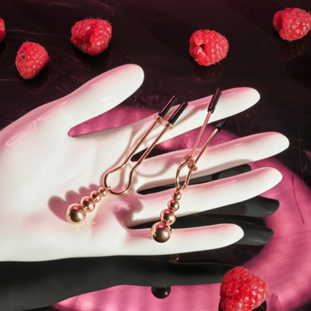 Rose gold beaded nipple clamps with adjustable rubber tips.
