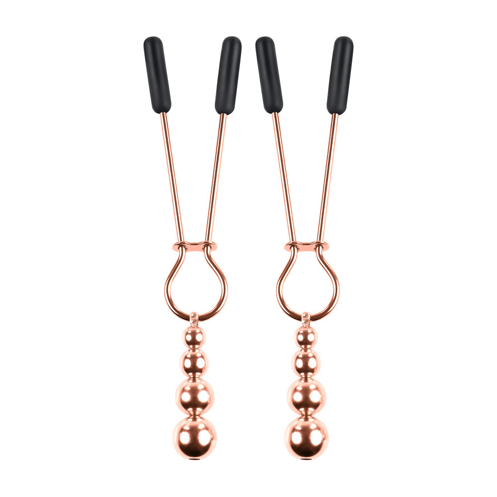 Rose gold nipple clamps with adjustable rubber tips and hanging beads.