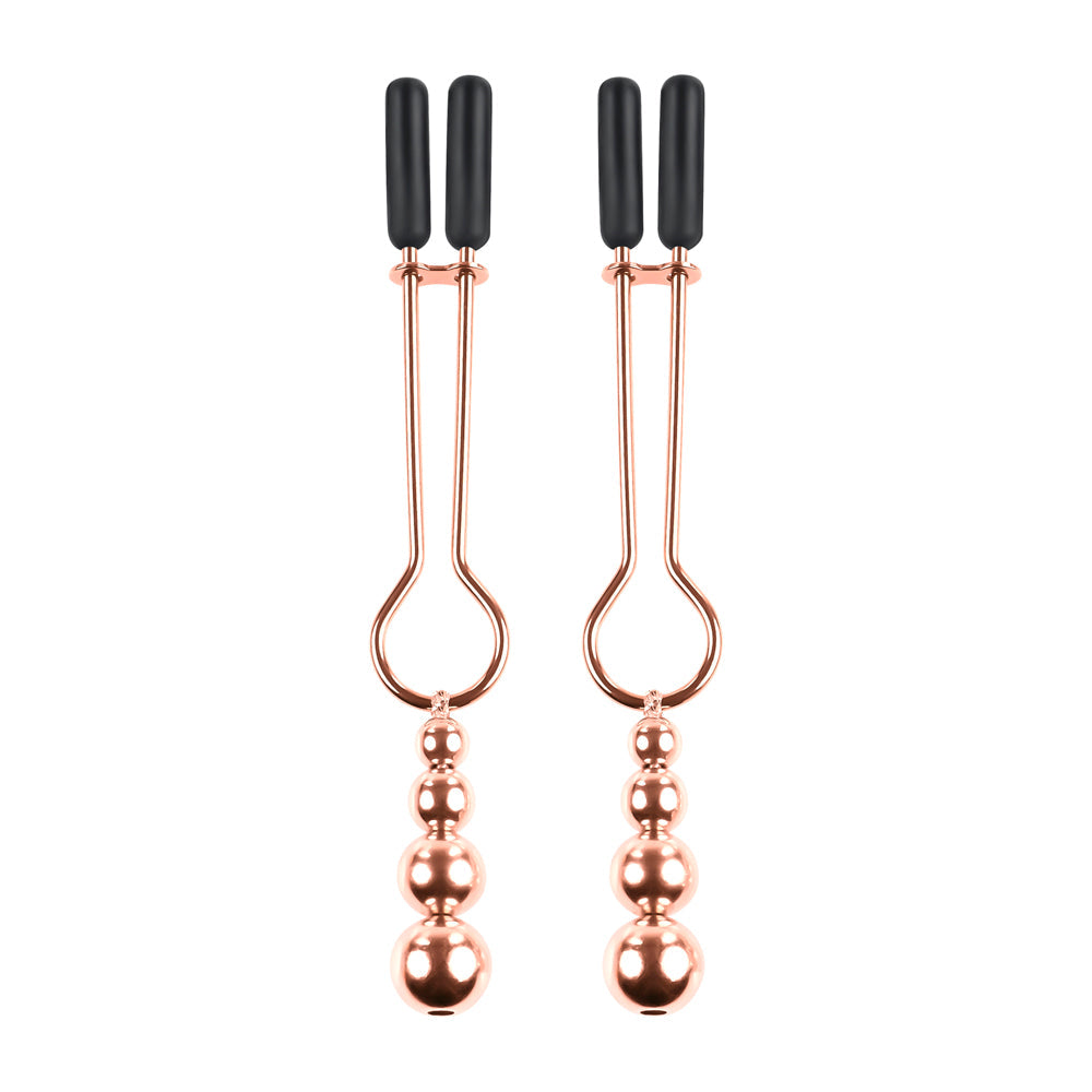 Rose gold nipple clamps with adjustable rubber tips and hanging beads.