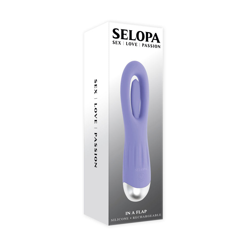 A purple silicone vibrator with a silver base on a white box.