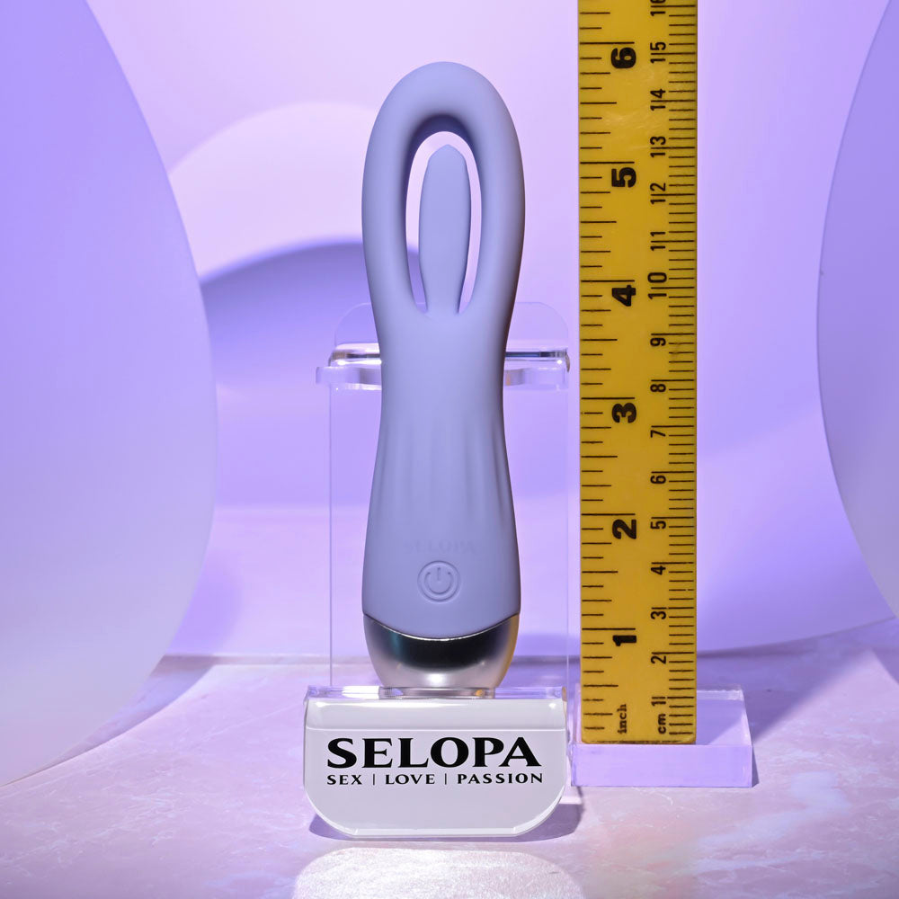 A purple silicone G-spot vibrator with a curved tip and flapping stimulator.