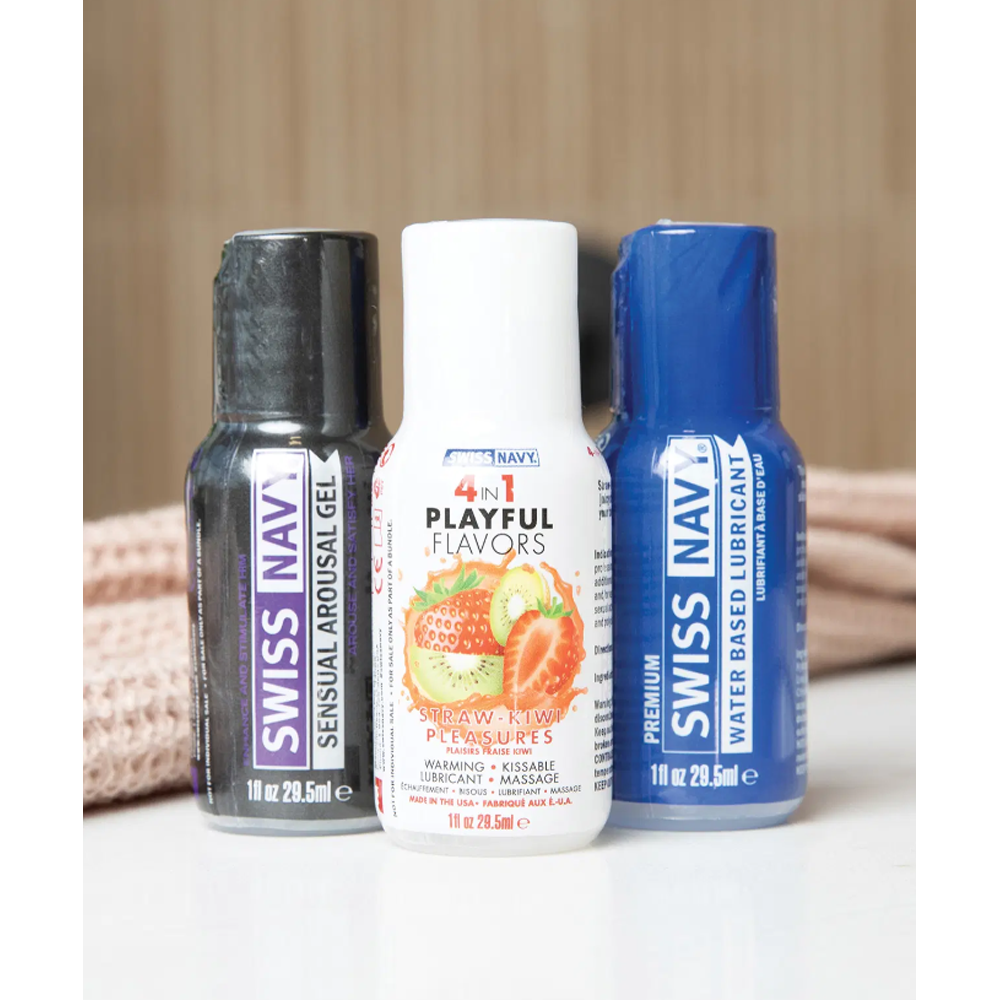 Three Swiss Navy bottles: arousal gel, strawberry kiwi lubricant, and water-based lubricant.