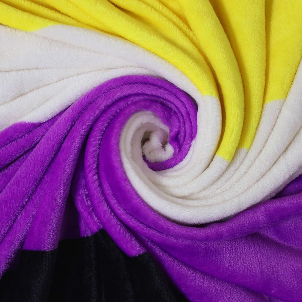 A plush fleece blanket with the Non-Binary pride flag colors.