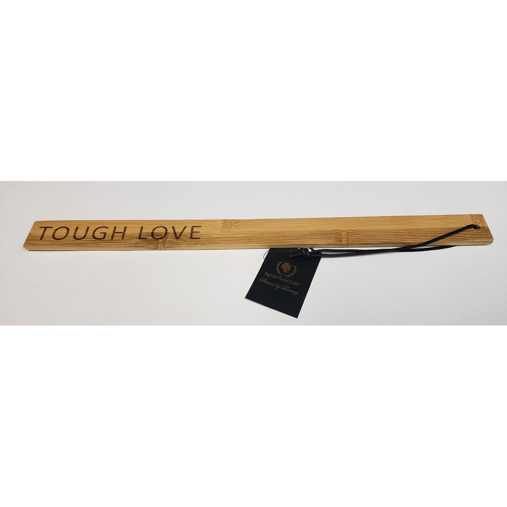 Bamboo paddle ruler with "Tough Love" engraved and a black tag.