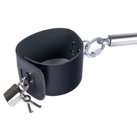 Adjustable steel spreader bar with black leather cuffs and lock.