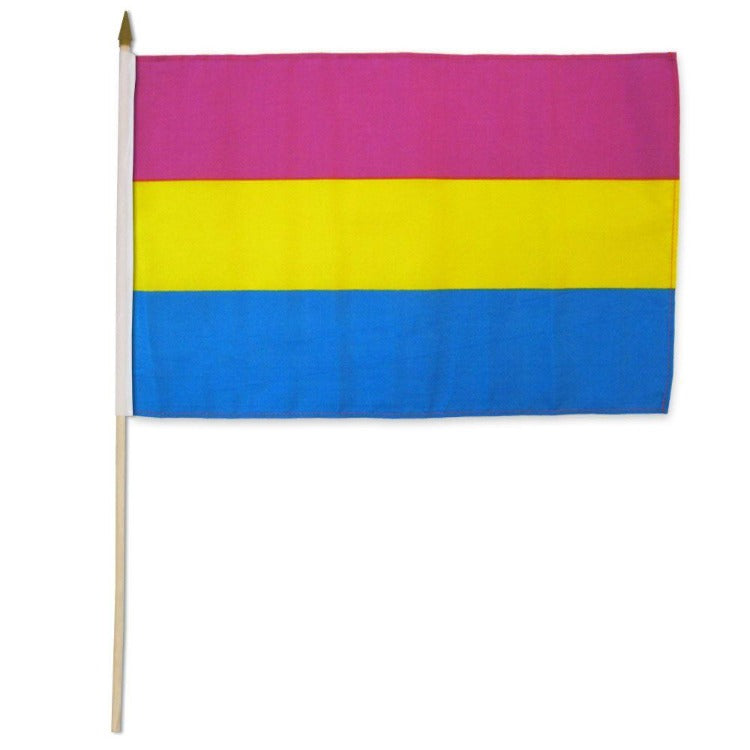 A pansexual pride flag with pink, yellow, and blue stripes on a wooden stick.