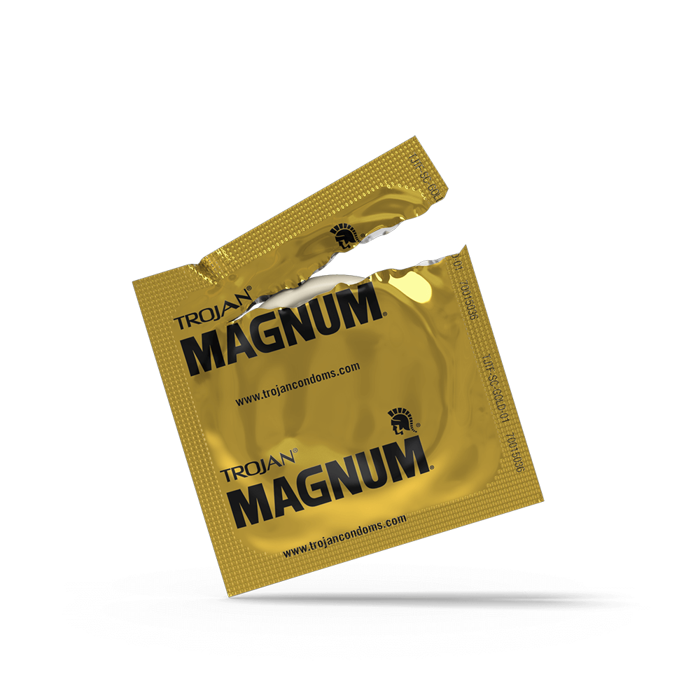 A gold wrapper for Trojan Magnum condoms is torn open, revealing a condom inside.