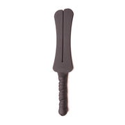 A dark gray silicone spanking paddle with a split head and a textured handle.