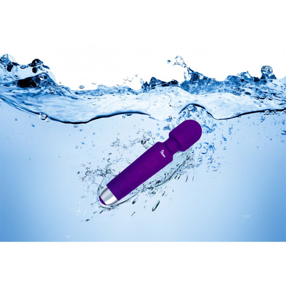 Purple waterproof wand massager with silver tip submerged in water.
