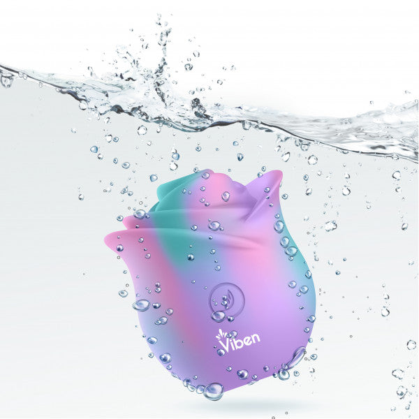 A rainbow-colored rose-shaped vibrator with the Viben logo submerged in water.