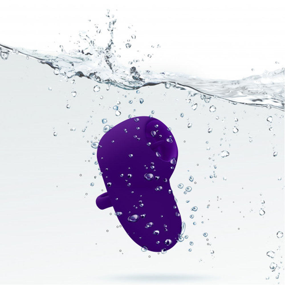 A purple flickering finger vibrator submerged in water.