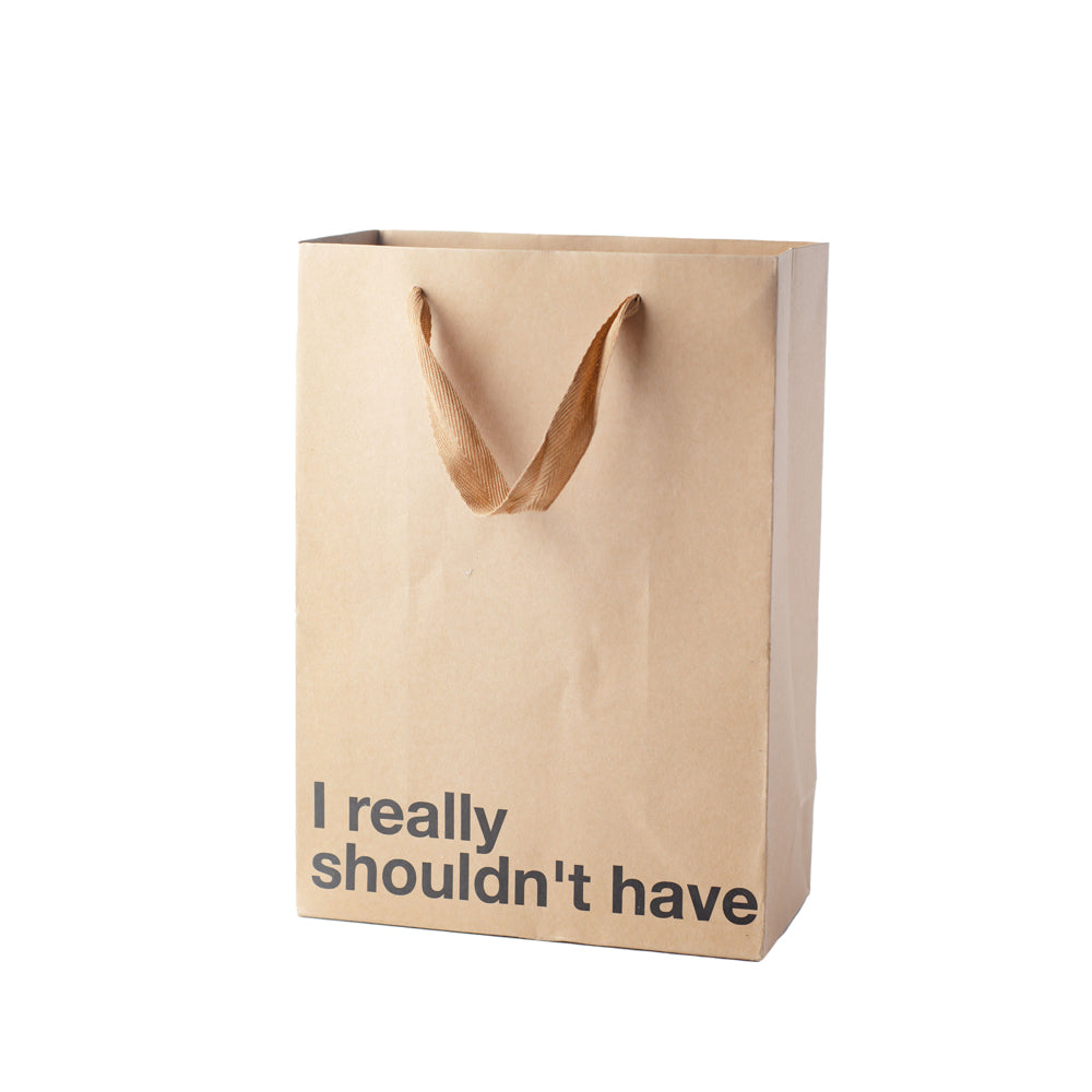 A brown kraft paper gift bag with ribbon handles and the text "I really shouldn't have".