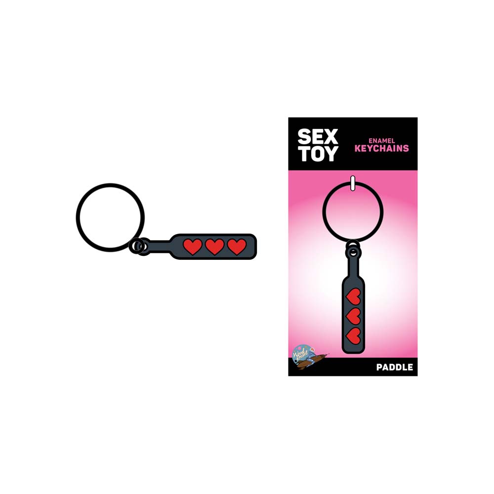 A black paddle keychain with three red hearts and a silver keyring.