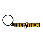 A keychain with a ring and the words "They/Them" in gold glitter lettering.