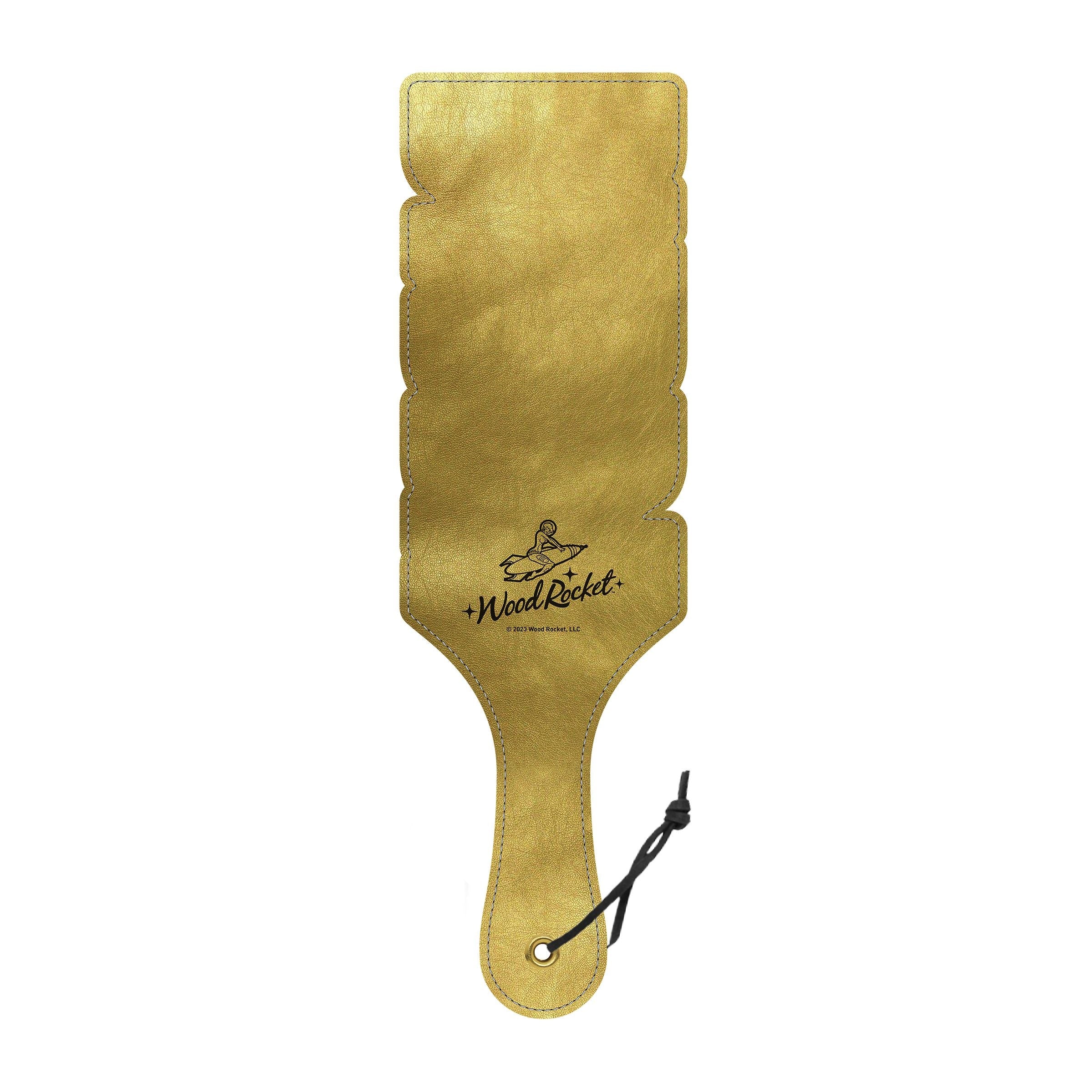 Gold cut-out daddy spanking paddle with a black wrist strap.