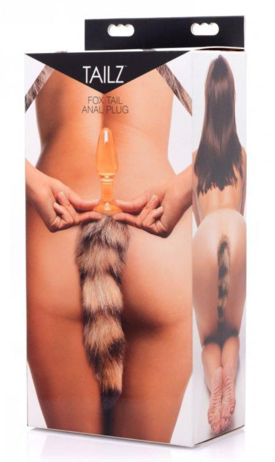 Orange glass anal plug with bushy fox tail on product box.