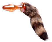 Orange glass anal plug with a brown and black striped fox tail.