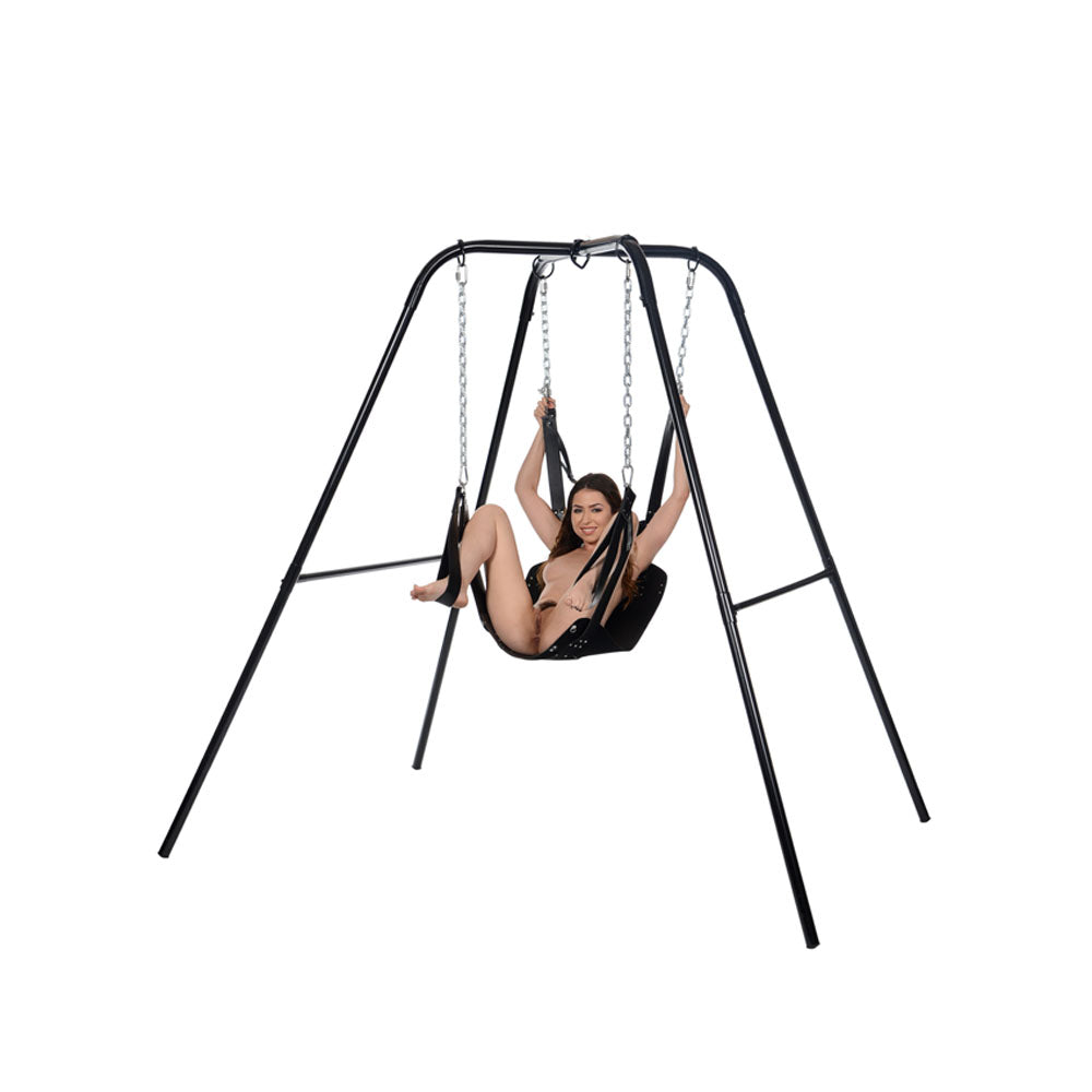 Black leather bondage sling with stirrups and pillow on a metal frame.