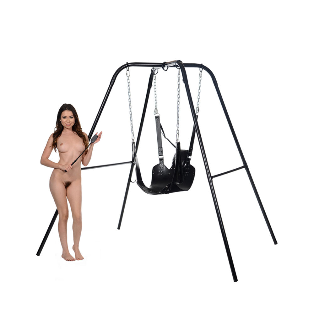 Black leather bondage sling with stirrups and pillow on metal frame.