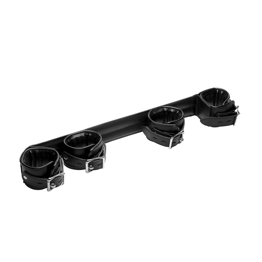 Rigid spreader bar with four padded black leather cuffs.