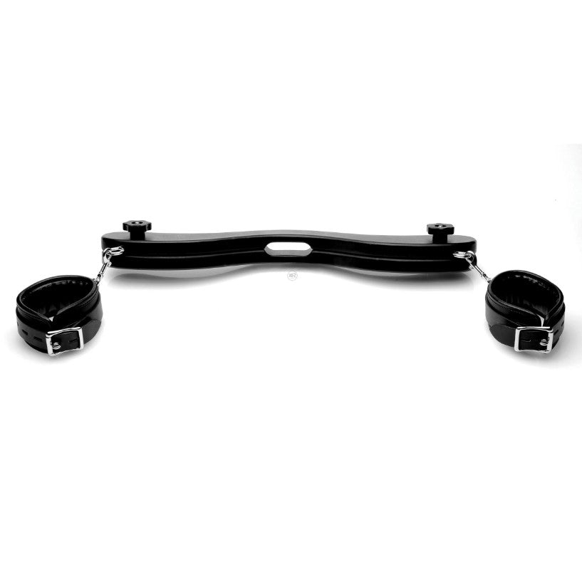 Black wooden humbler with ankle restraints and adjustable cuffs.