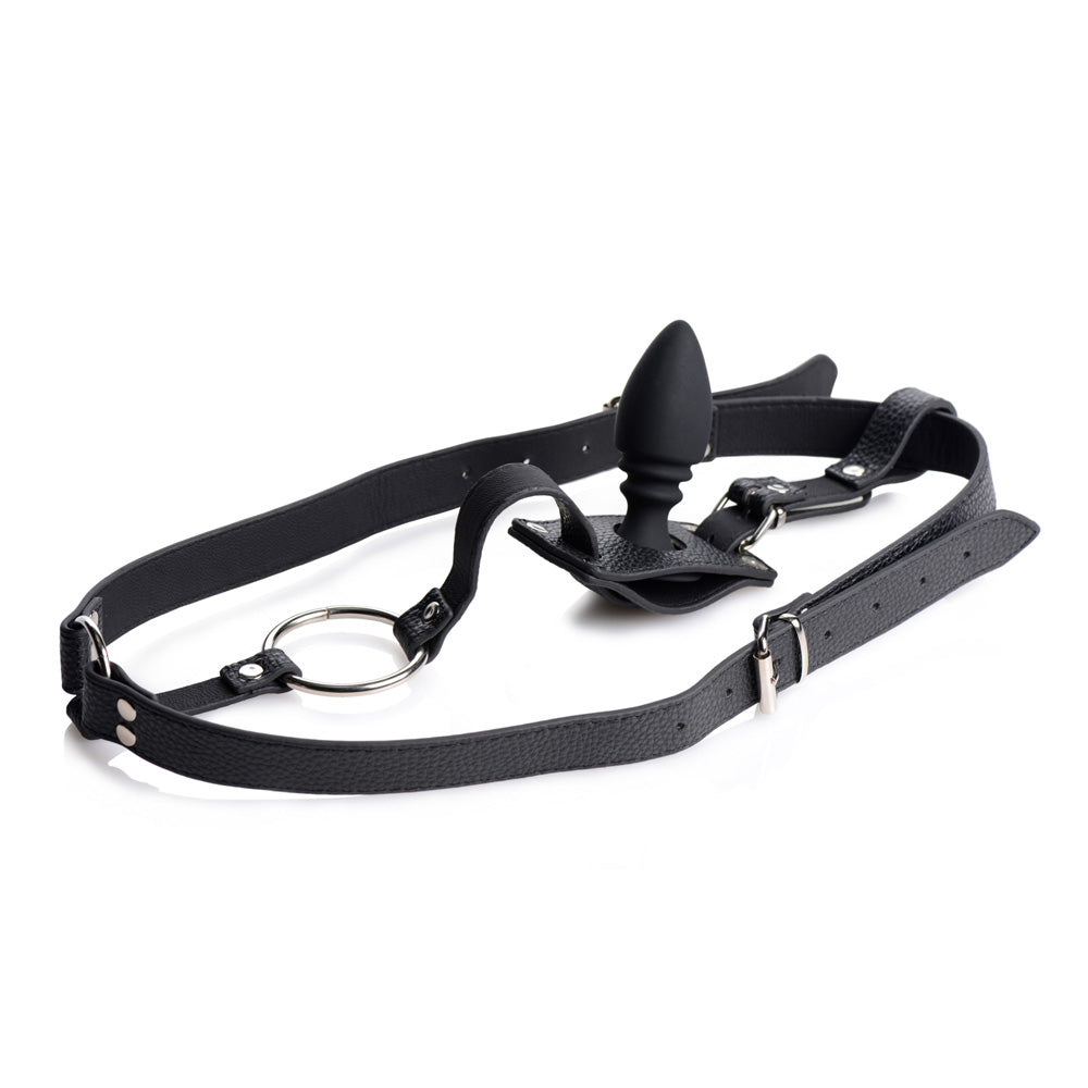 Black leather harness with a silicone anal plug and metal ring.