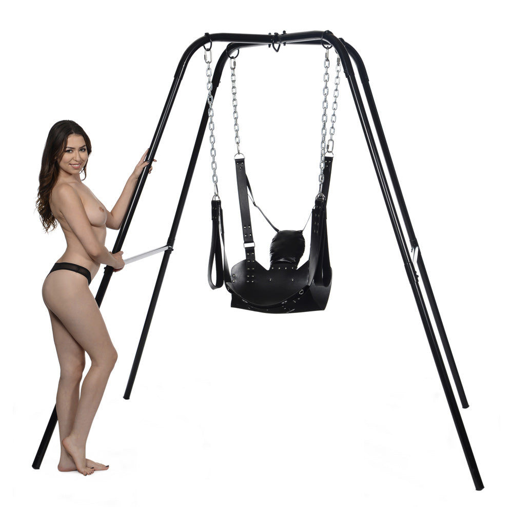 Black metal swing stand with a leather sling and a woman standing next to it.