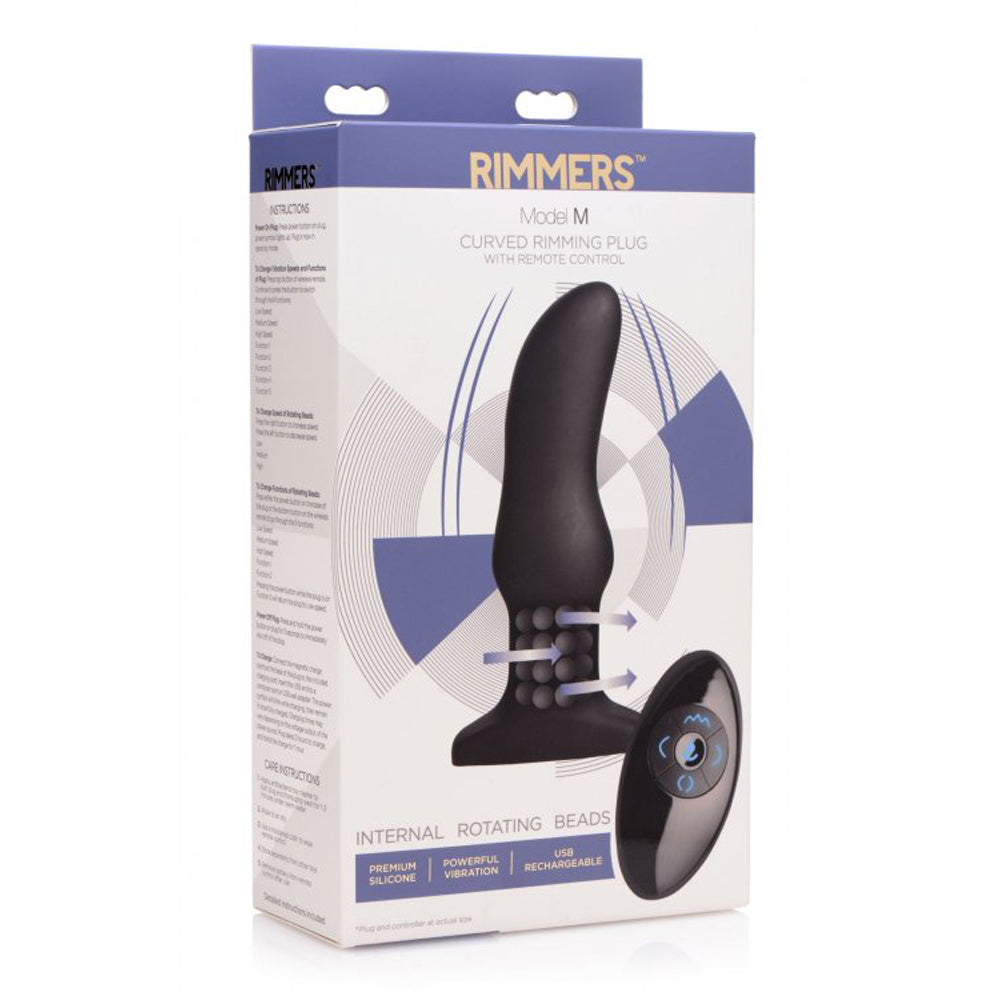 A black curved anal massager with rotating beads and a remote control on its box.