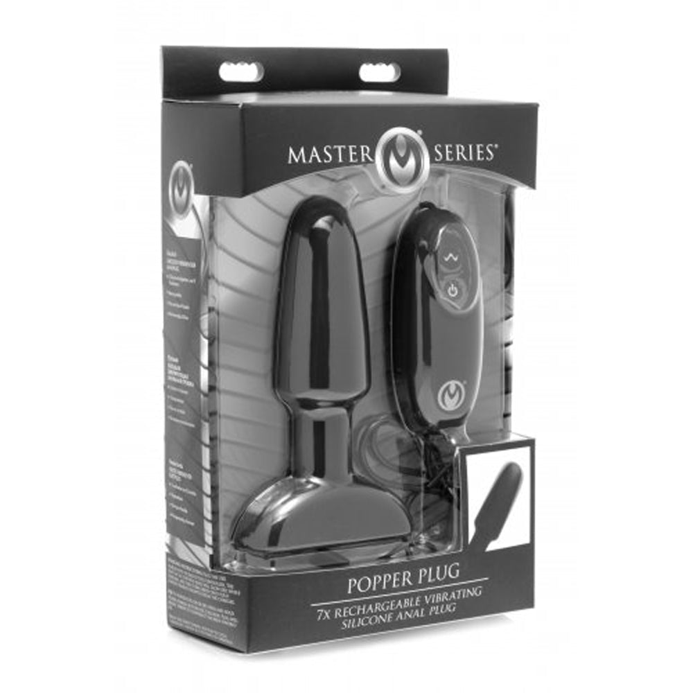 A black vibrating silicone anal plug with a remote control in its packaging.