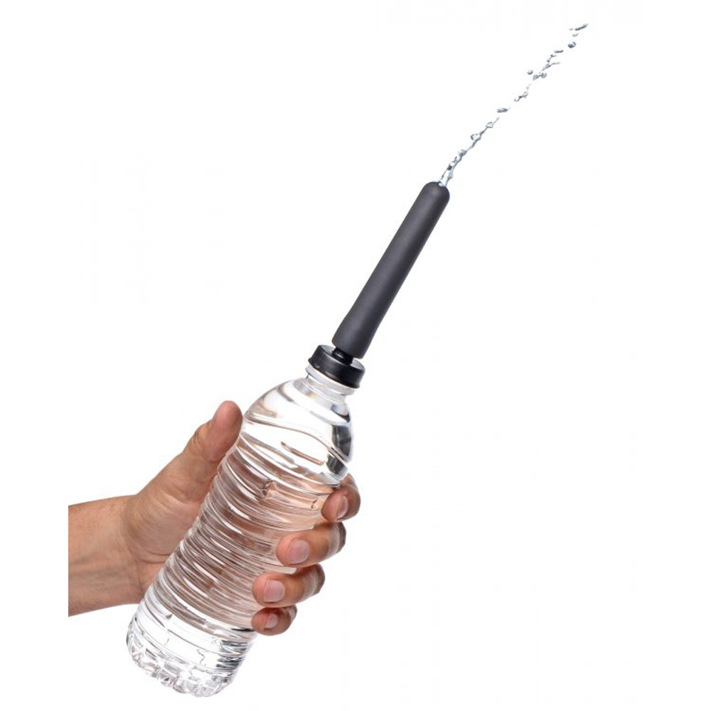 Hand holding a water bottle with a black adapter and water spraying from it.