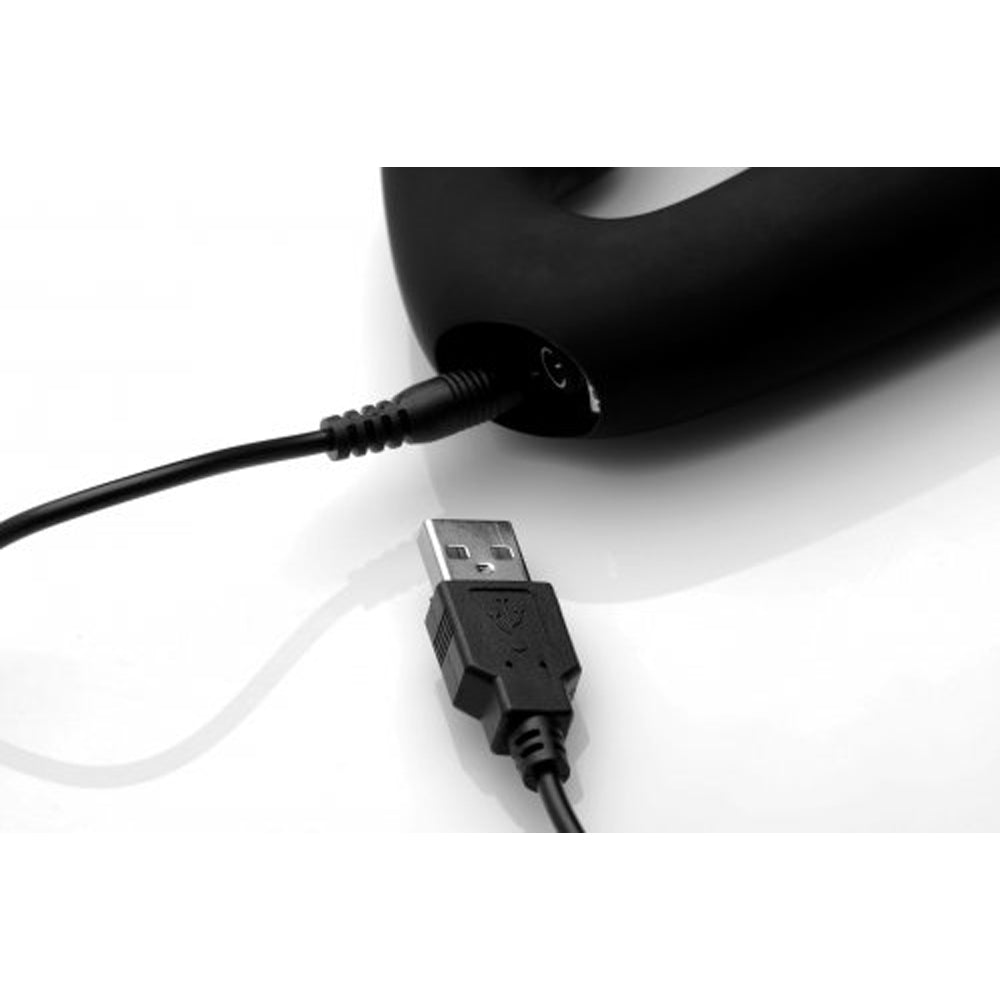 Black silicone strapless strap-on with USB charging cable.