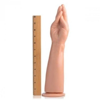 A flesh-toned dildo shaped like a hand and forearm with a ruler for scale.