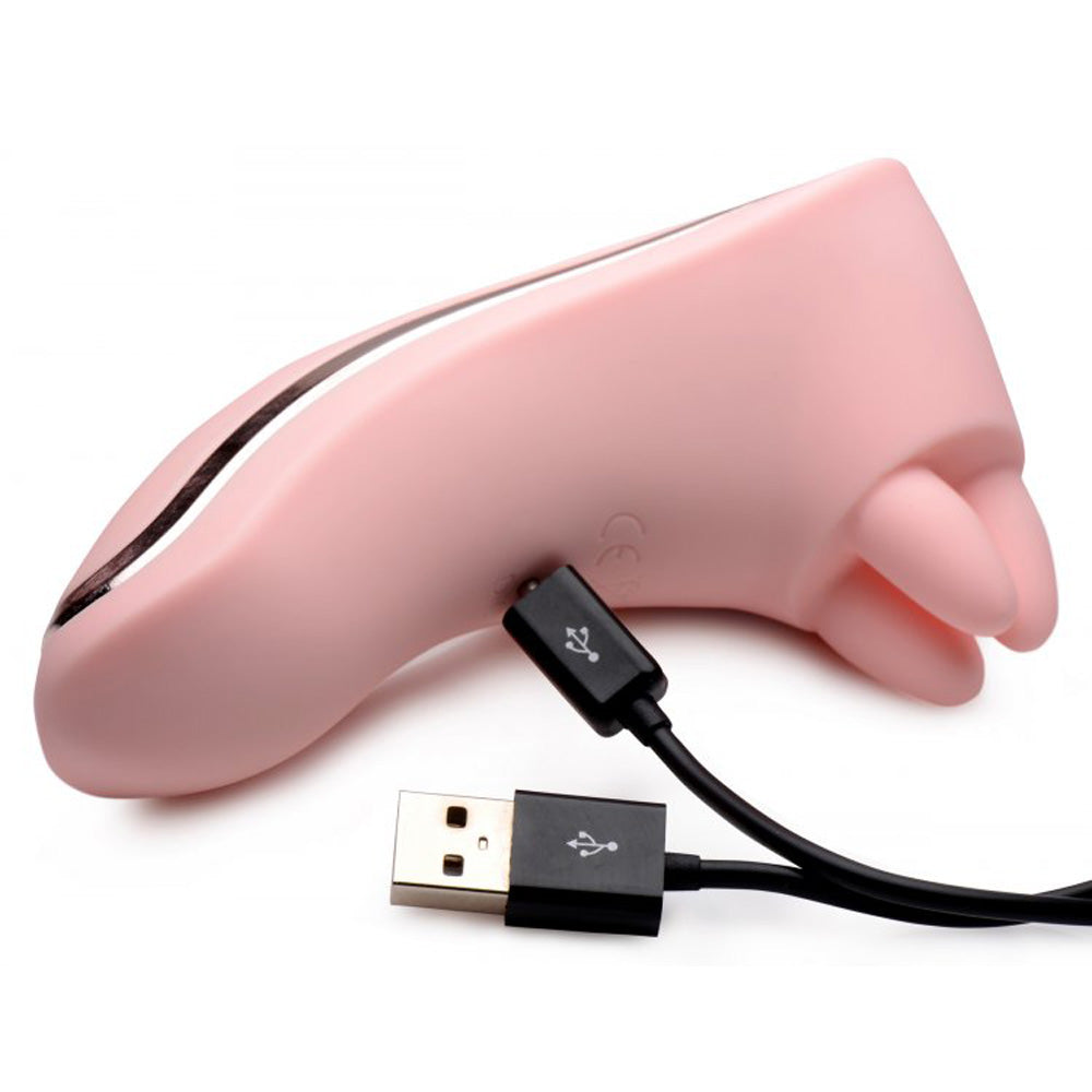 Pink rechargeable silicone clitoral massager with USB charging cable.