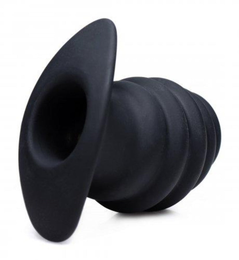 Black ribbed hollow silicone anal tunnel plug.