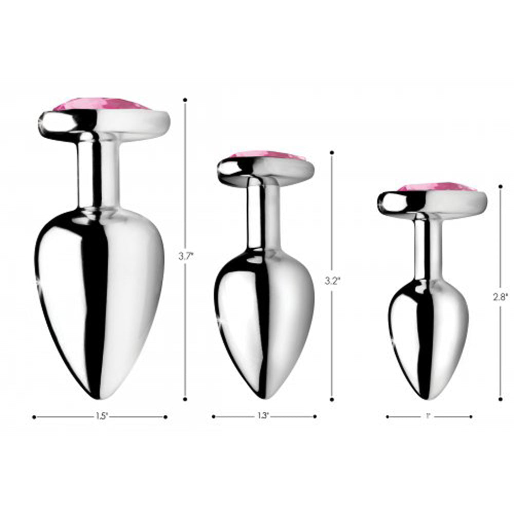 Three silver anal plugs with pink heart gems in varying sizes.