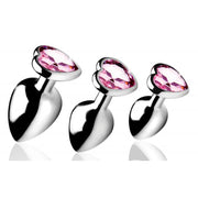 Three silver anal plugs with pink heart-shaped gems.