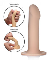 A beige, flexible silicone dildo with a suction base.
