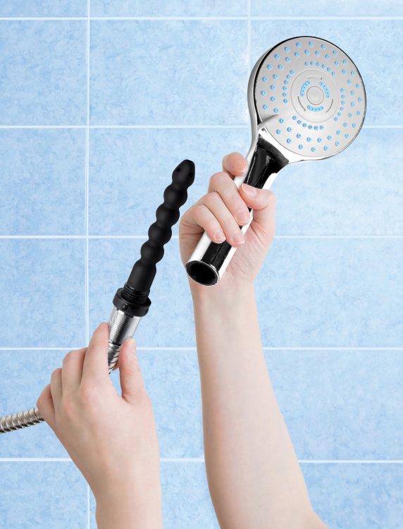 Silver shower head with a black silicone enema nozzle attached to the hose.