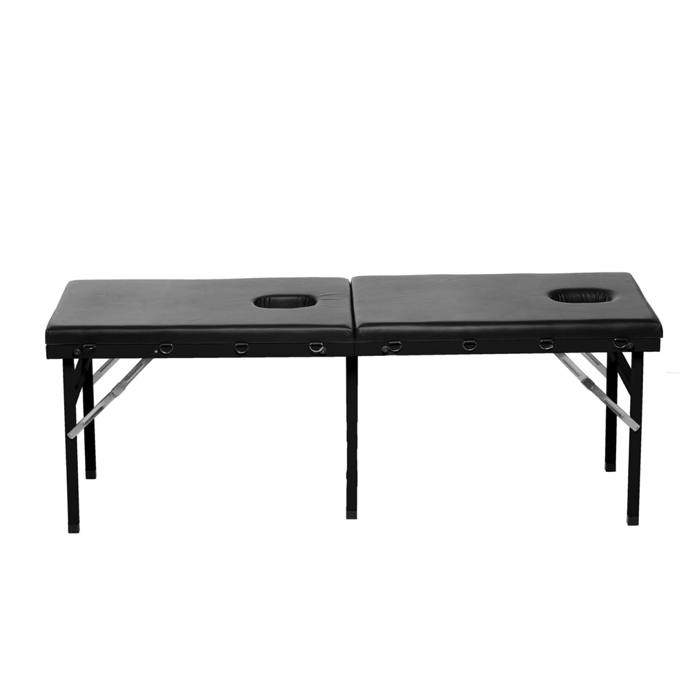 A black PU leather massage table with two face holes and metal legs.