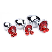Three silver anal plugs with red gems and bells.