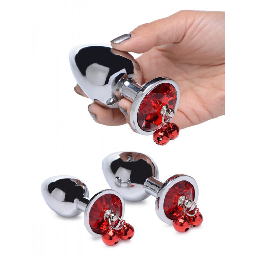 A set of three chrome anal plugs with red gems and dangling bells.