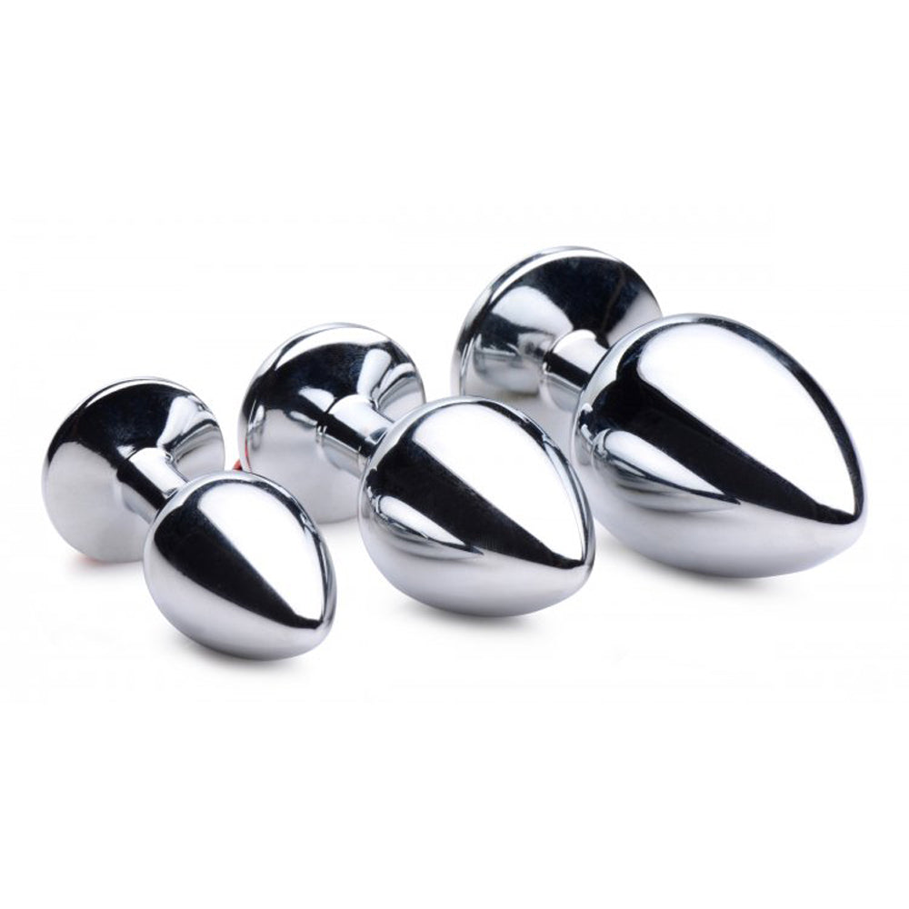 Set of three graduated aluminum anal plugs with red gems and bells.