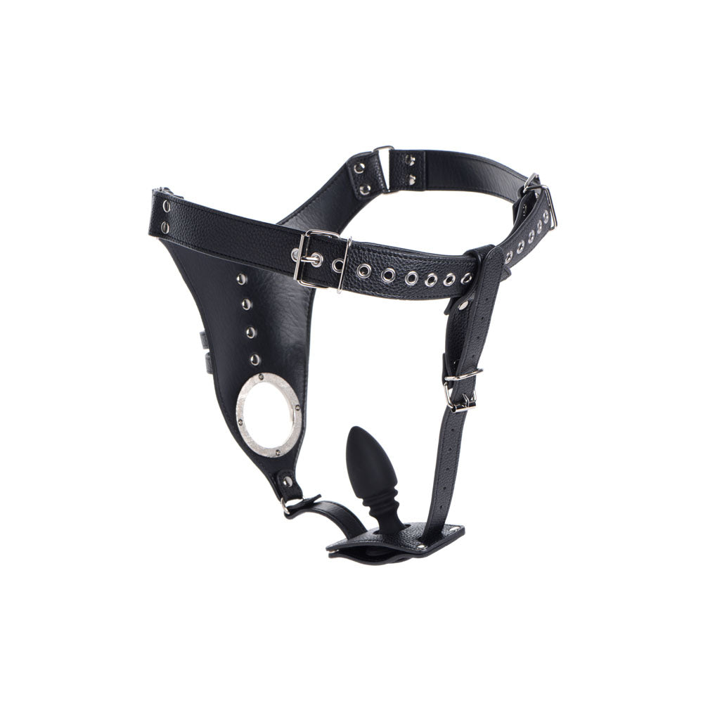 Black leather chastity harness with a silicone anal plug.