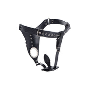 Black leather chastity harness with a silicone anal plug.